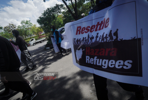 Sejumlah pengungsi asal Afghanistan melakukan aksi jalan kaki di jalan Basuki Rahmat, Embong Malang, Bubutan hingga jalan Pahlawan, Surabaya, Jawa Timur, Selasa, 24 Mei 2022. Dalam aksi jalan kaki tersebut mereka meminta kejelasan status dan kepastian untuk berangkat ke negara ketiga setelah lama tinggal di pengungsian. Foto: Julian Romadhon 