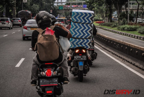 Para pemudik di jl. Kalimalang, Jakarta yang membawa barang bawaan dengan sepeda motor.