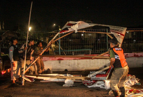 Petugas Satpol PP bersama Badan Pengawas Pemilihan Umum (Bawaslu) Kota Surabaya melakukan penertiban dan pembersihan alat peraga kampanye (APK) yang masih terpasang di ruas-ruas jalan lintas Kota Surabaya, Jawa Timur,  Minggu, 11 Februari 2024. Penertiban dan pembersihan APK tersebut dilakukan karena telah memasuki masa tenang jelang pelaksanaan Pemilu 14 Februari 2024. (Moch Sahirol/Harian Disway)