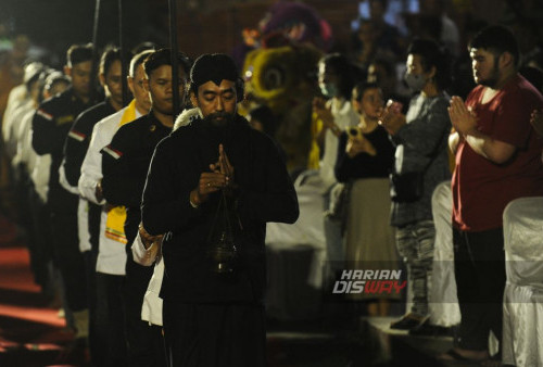 Panggung berhias gapura bentar di depan Tugu Proklamasi Alun-Alun Mojokerto menjadi saksi keindahan acara ini. Di sampingnya, altar Buddha dengan rupang putih memancarkan kedamaian dan keheningan. Aroma harum semerbak wangi dupa dan kemenyan menyelimuti udara, sementara asap membubung membentuk lingkaran mistis di ruang terbuka sebelah utara alun-alun tersebut.
