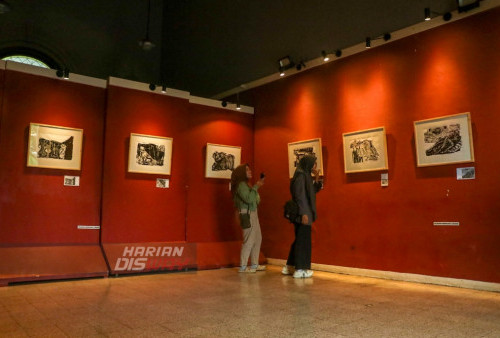 Pengunjung mengamati lukisan yang dipamerkan di Galeri Merah Putih, Komplek Alun-alun, Surabaya, Jawa Timur, Sabtu 29 Juli 2023. Pameran tunggal grafis murni karya Arief Wong tersebut mengusung tema 