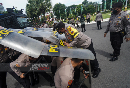 Sejumlah anggota polisi dari Polrestabes Surabaya melakukan latihan penanganan unjuk rasa di halaman Gedung Negara Grahadi Surabaya, Jawa Timur, Senin (9/5). Latihan tersebut digelar untuk meningkatkan kemampuan anggota kepolisian dalam melakukan penanganan dan pengamanan unjuk rasa khususnya yang berujung anarkis. Foto: Julian Romadhon